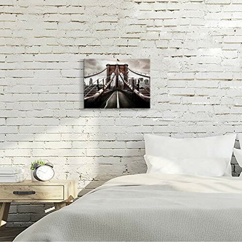 Bedroom with white brick wall and bridge photo art above bed