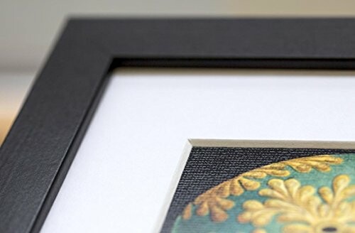 Close-up of a framed picture corner with decorative design.