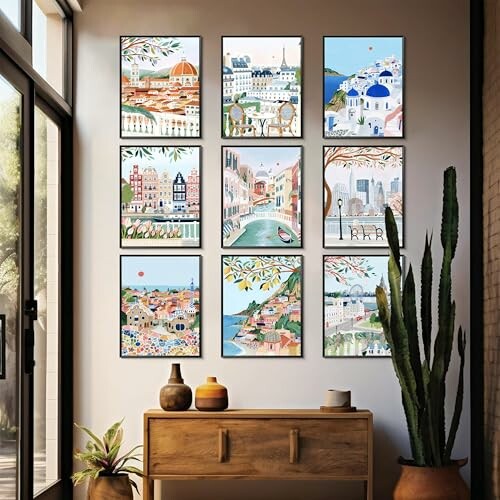 Nine framed cityscape paintings on a wall with a wooden console and plants. Create a cohesive gallery wall or mix and match with your existing frames to add a personal touch to your space.