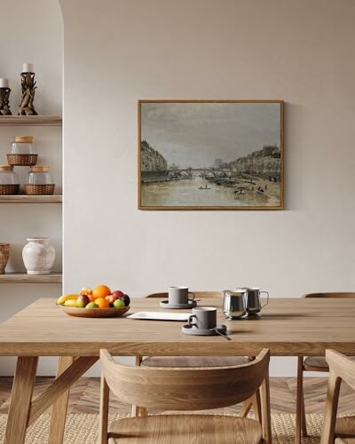 Dining room with wooden table, chairs, fruit bowl, and wall art.