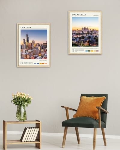 Room with framed city prints of Chicago and Los Angeles on wall above chair and table with flowers.