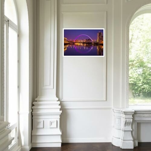 Framed cityscape artwork on a white wall in a classic interior.