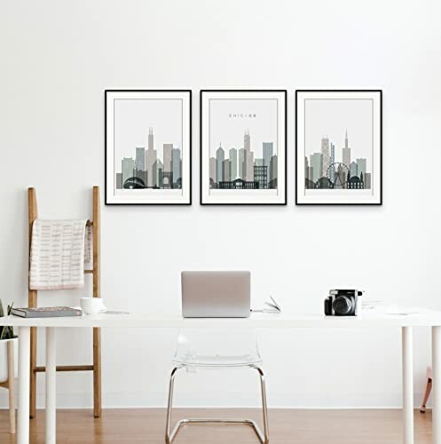 Minimalist office with framed city skyline artwork.