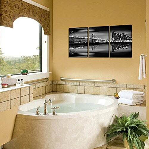 Luxurious bathroom with corner bathtub and cityscape wall art.