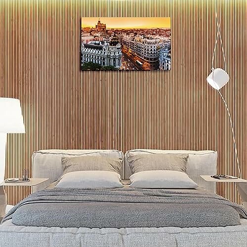 A modern bedroom with a cityscape painting on the wall.