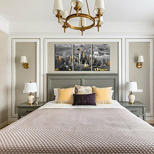 Stylish bedroom with gray and yellow decor, featuring a cityscape wall art.