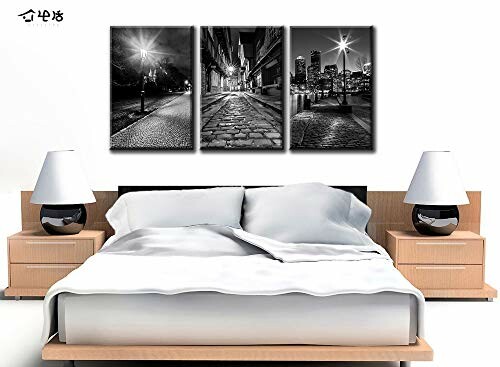 Bedroom with modern black and white cityscape wall art above bed