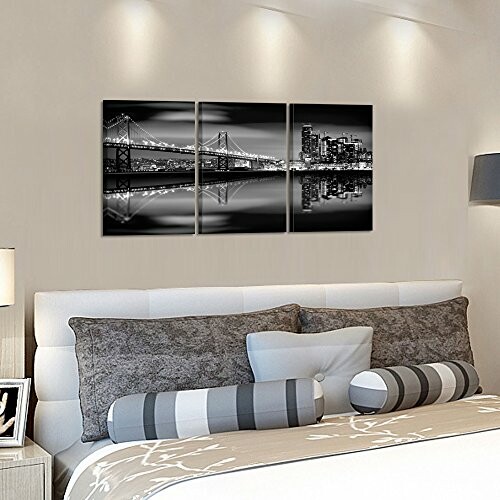 Modern bedroom with black and white cityscape wall art.