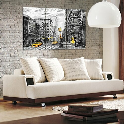 Living room with a white sofa and urban cityscape artwork on the wall.