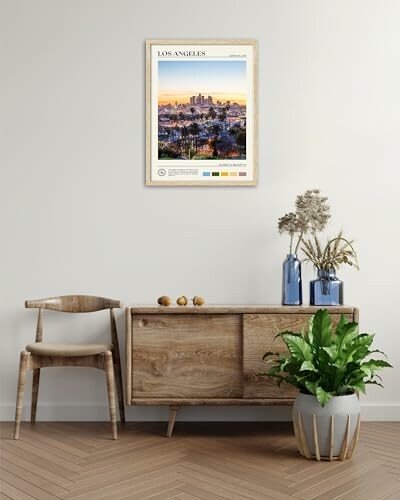 Stylish living room with framed Los Angeles poster, wooden furniture, and decorative plants.