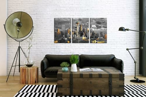 Modern living room with black sofa, industrial decor, and Seattle skyline art on brick wall.