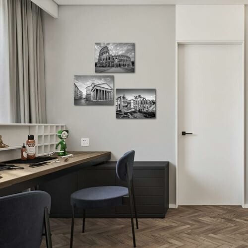 Office space with modern desk and black-and-white wall art.