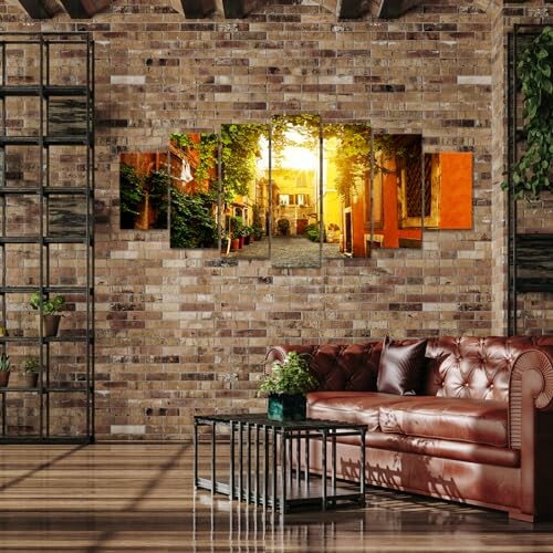 Rustic living room with brick walls, brown leather sofa, and multi-panel wall art.