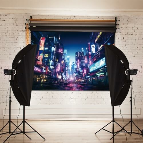 Photo studio setup with urban city backdrop and lighting equipment.