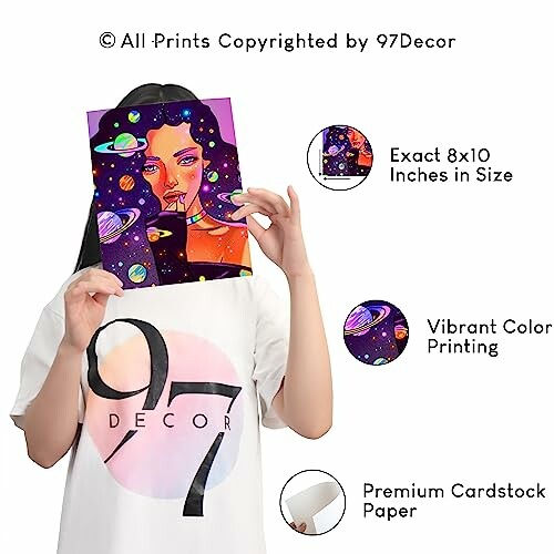 Person holding a vibrant space-themed art print with planets.